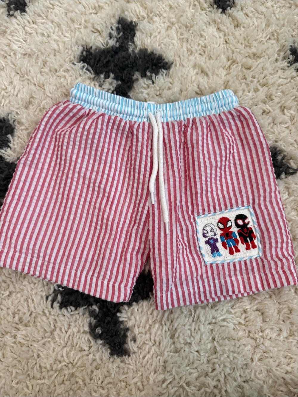 Smocked spidey & friends swim trunks